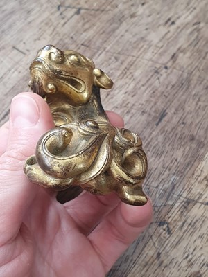 Lot 649 - A CHINESE GILT-BRONZE 'QILIN' PAPERWEIGHT.