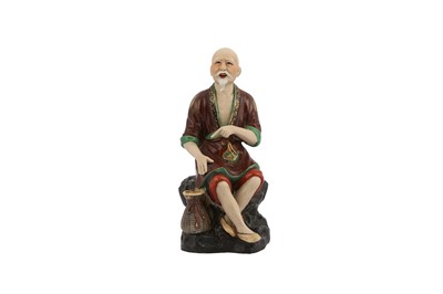 Lot 254 - A CHINESE GLAZED SEATED FIGURE.