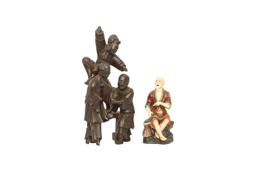 Lot 270 - A CHINESE WOOD FIGURATIVE GROUP AND A PORCELAIN FIGURE OF A SAGE.