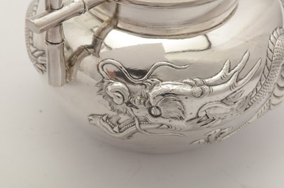 Lot 248 - An early 20th century Chinese Export silver three-piece tea service, Canton circa 1900 retailed by Wang Hing