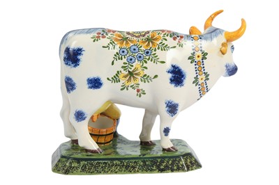Lot 86 - A DUTCH DELFT POTTERY FIGURE OF A MAN AND A COW, 20TH CENTURY