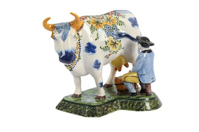 Lot 86 - A DUTCH DELFT POTTERY FIGURE OF A MAN AND A COW, 20TH CENTURY