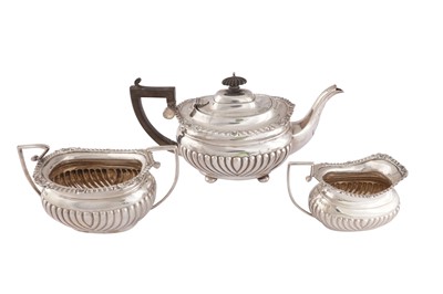 Lot 888 - AN EDWARDIAN STERLING SILVER THREE PIECE TEA SERVICE, CHESTER 1909 BY NATHAN AND HAYES