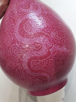 Lot 143 - A CHINESE PINK-GROUND SGRAFFITO 'DRAGON' BOTTLE VASE.