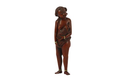 Lot 253 - λ A BOXWOOD CARVING OF A YOUNG GIRL WITH IVORY INLAY.