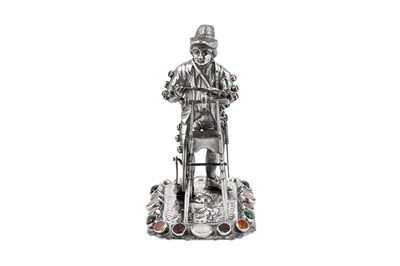 Lot 40 - A late 19th century / early 20th century German silver and paste set model of a man sharpening a knife, Hanau circa 1900 by B. Neresheimer & Sohne