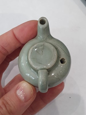 Lot 265 - A CHINESE FAMILLE ROSE SNUFF BOTTLE, A CELADON-GLAZED MINIATURE TEAPOT AND A VASE.