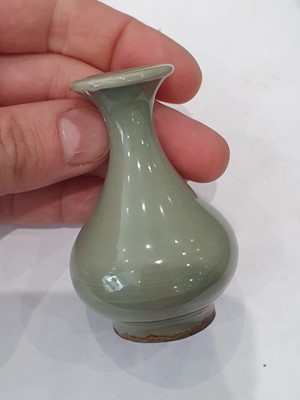 Lot 265 - A CHINESE FAMILLE ROSE SNUFF BOTTLE, A CELADON-GLAZED MINIATURE TEAPOT AND A VASE.