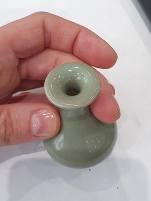 Lot 265 - A CHINESE FAMILLE ROSE SNUFF BOTTLE, A CELADON-GLAZED MINIATURE TEAPOT AND A VASE.