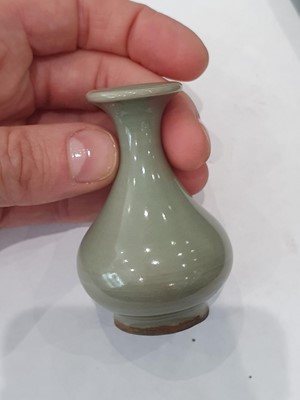 Lot 265 - A CHINESE FAMILLE ROSE SNUFF BOTTLE, A CELADON-GLAZED MINIATURE TEAPOT AND A VASE.