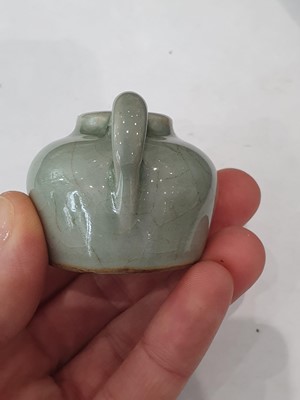 Lot 265 - A CHINESE FAMILLE ROSE SNUFF BOTTLE, A CELADON-GLAZED MINIATURE TEAPOT AND A VASE.