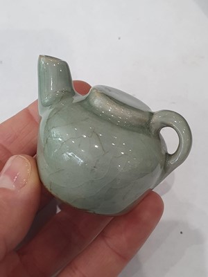 Lot 265 - A CHINESE FAMILLE ROSE SNUFF BOTTLE, A CELADON-GLAZED MINIATURE TEAPOT AND A VASE.