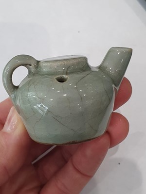 Lot 265 - A CHINESE FAMILLE ROSE SNUFF BOTTLE, A CELADON-GLAZED MINIATURE TEAPOT AND A VASE.
