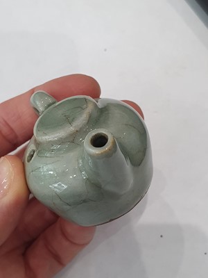 Lot 265 - A CHINESE FAMILLE ROSE SNUFF BOTTLE, A CELADON-GLAZED MINIATURE TEAPOT AND A VASE.