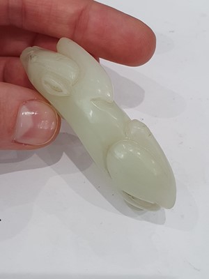 Lot 62 - A CHINESE PALE CELADON JADE 'DOG' CARVING.
