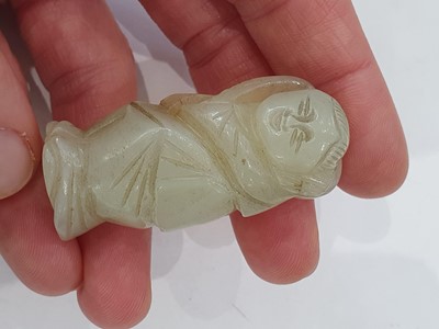 Lot 246 - TWO CHINESE PALE CELADON JADE FIGURES AND AN ARCHER'S RING.