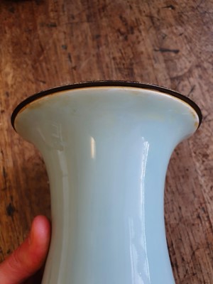 Lot 121 - A CHINESE SLIP-DECORATED CELADON 'DRAGONS' VASE.