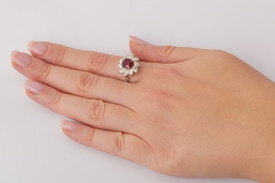 Lot 182 - A ruby and diamond cluster ring
