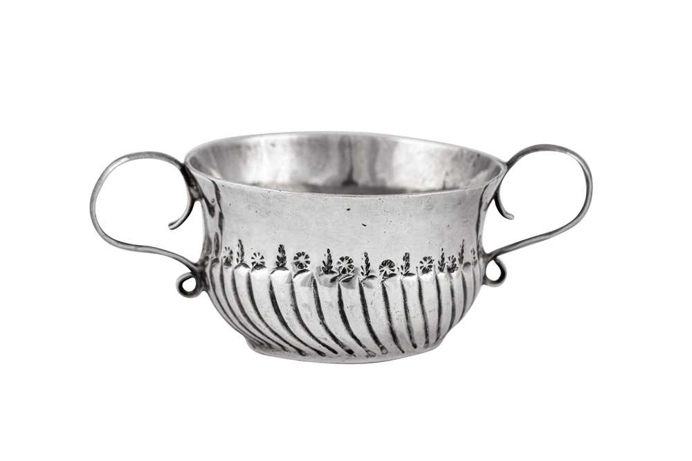 Lot 70 - A Queen Anne unmarked silver 'toy' miniature twin handled porringer or caudle cup, London  circa 1705