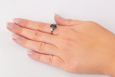 Lot 58 - A sapphire and diamond three-stone ring