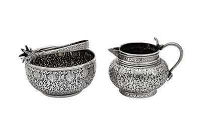 Lot 159 - A late 19th century Indian unmarked silver milk jug and sugar bowl with sugar tongs, Lucknow circa 1890