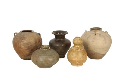 Lot 571 - FIVE SOUTH-EAST ASIAN POTTERY JARS.