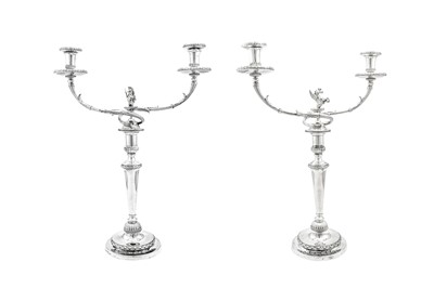 Lot 681 - A pair of George III sterling silver two light candelabra, Birmingham 1800 by Mathew Boulton and London 1800 by Richard Cook