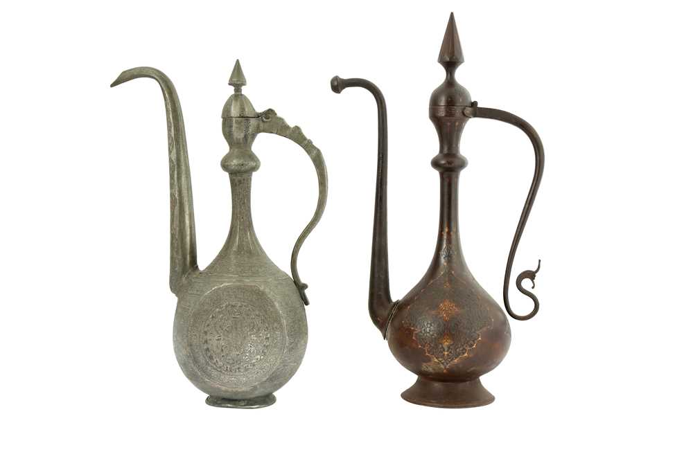 Lot 105 - A QAJAR GOLD-DAMASCENED STEEL EWER AND AN ENGRAVED TINNED COPPER EWER
