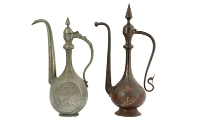 Lot 105 - A QAJAR GOLD-DAMASCENED STEEL EWER AND AN ENGRAVED TINNED COPPER EWER