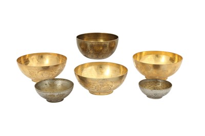 Lot 1075 - FIVE ENGRAVED BRASS MAGIC BOWLS AND A QAJAR BOWL WITH FIGURAL DECORATION