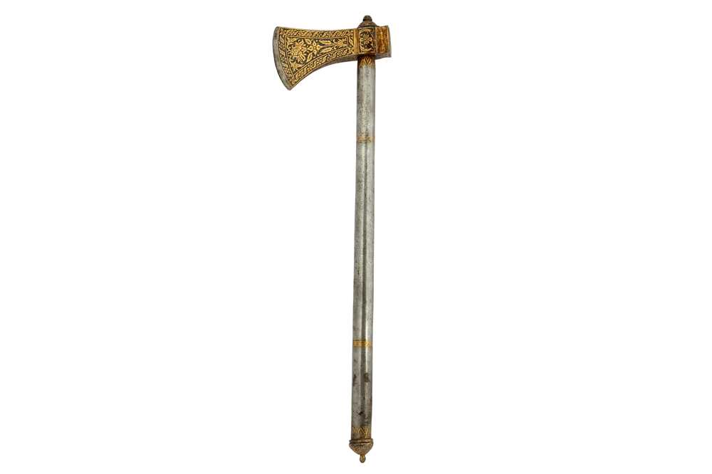 Lot 152 - A PERSIAN CEREMONIAL STEEL AXE WITH GOLD-DAMASCENED HEAD (TABARZIN)