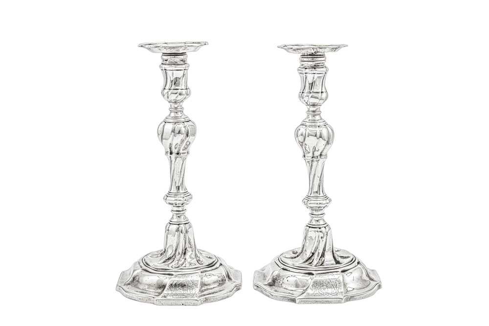 Lot 701 - An unusual pair of George II sterling silver candlesticks, London 1754 by John Wirgman (reg. 13th May 1751)