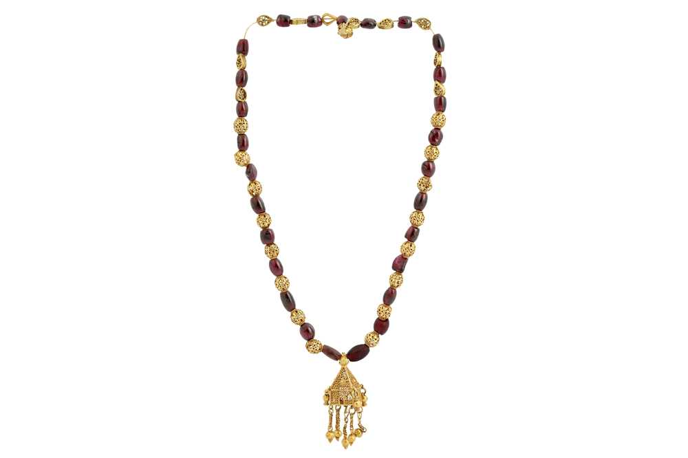 Lot 167 - A GARNET BEAD NECKLACE WITH GOLD FILIGREE PENDANT