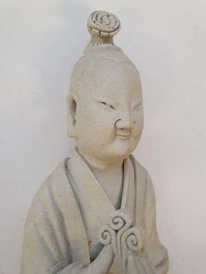 Lot 879 - A CHINESE PART-GLAZED BISCUIT FIGURE OF AN IMMORTAL.