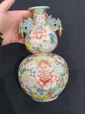 Lot 279 - A CHINESE FAMILLE ROSE 'MILLEFLEURS' DOUBLE GOURD VASE.
