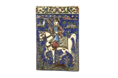 Lot 510 - A MOULDED QAJAR POTTERY TILE WITH RIDER