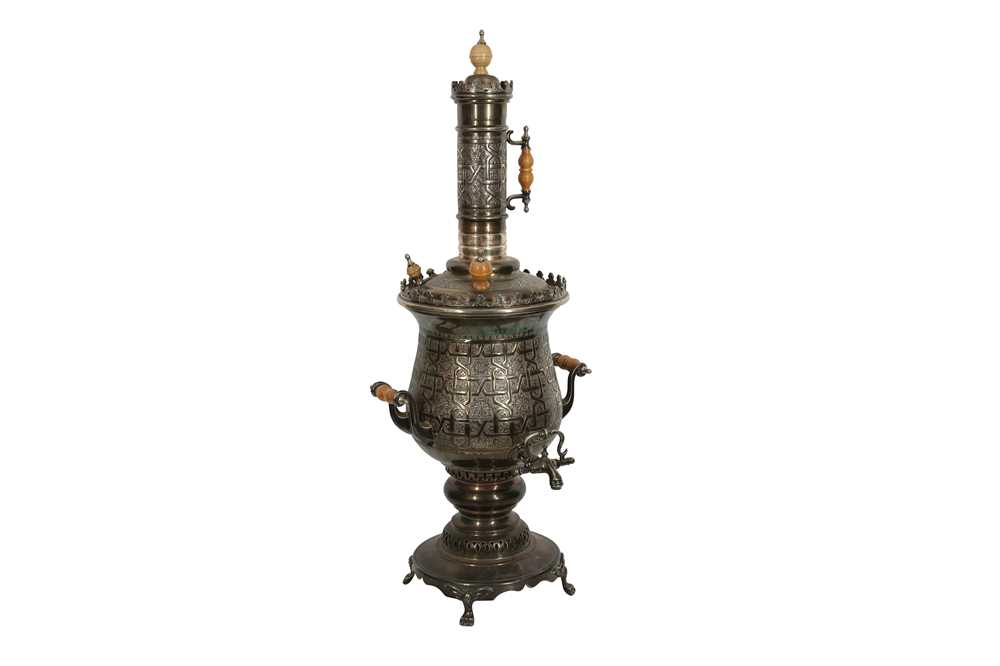 Lot 630 - A LARGE PLATED BRASS SAMOVAR ENGRAVED WITH ISLAMIC MOTIFS