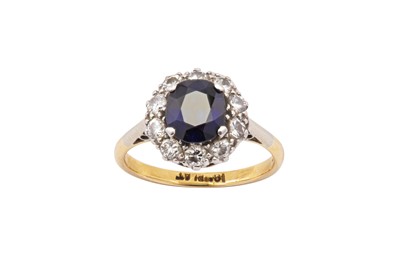 Lot 21 - A sapphire and diamond cluster ring