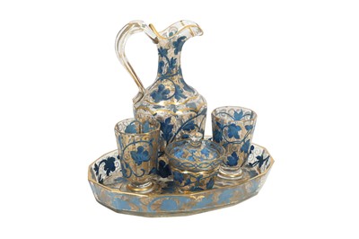 Lot 631 - A GILT AND BLUE-PAINTED TRANSPARENT GLASS DRINKING SET MADE FOR THE MIDDLE EASTERN MARKET