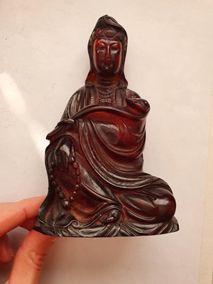Lot 607 - A CHINESE RECOMPOSITED AMBER FIGURE OF GUANYIN.