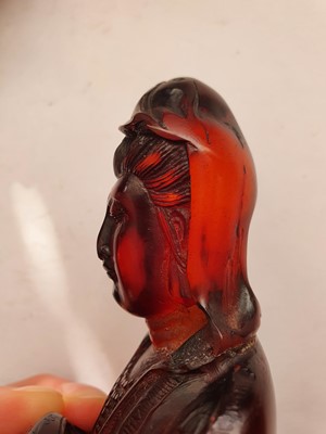 Lot 607 - A CHINESE RECOMPOSITED AMBER FIGURE OF GUANYIN.