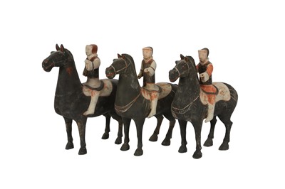 Lot 356 - A SET OF THREE CHINESE POTTERY HORSES AND RIDERS.