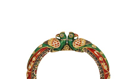 Lot 363 - TWO GILT AND POLYCHROME-ENAMELLED BANGLES WITH PARROT HEADS