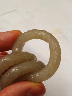Lot 917 - FOUR CHINESE CARVED WHITE JADE CONJOINED RINGS.