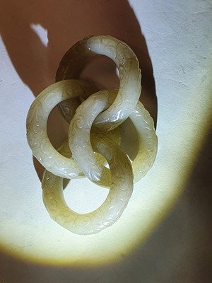 Lot 917 - FOUR CHINESE CARVED WHITE JADE CONJOINED RINGS.