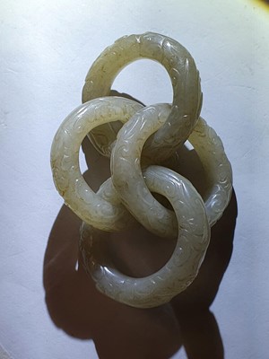 Lot 917 - FOUR CHINESE CARVED WHITE JADE CONJOINED RINGS.