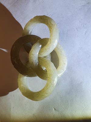 Lot 917 - FOUR CHINESE CARVED WHITE JADE CONJOINED RINGS.