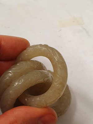Lot 917 - FOUR CHINESE CARVED WHITE JADE CONJOINED RINGS.
