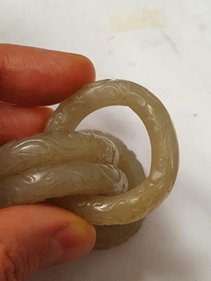 Lot 917 - FOUR CHINESE CARVED WHITE JADE CONJOINED RINGS.