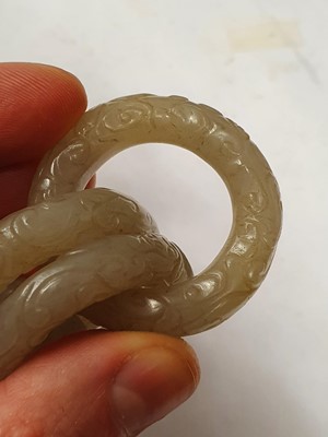 Lot 917 - FOUR CHINESE CARVED WHITE JADE CONJOINED RINGS.